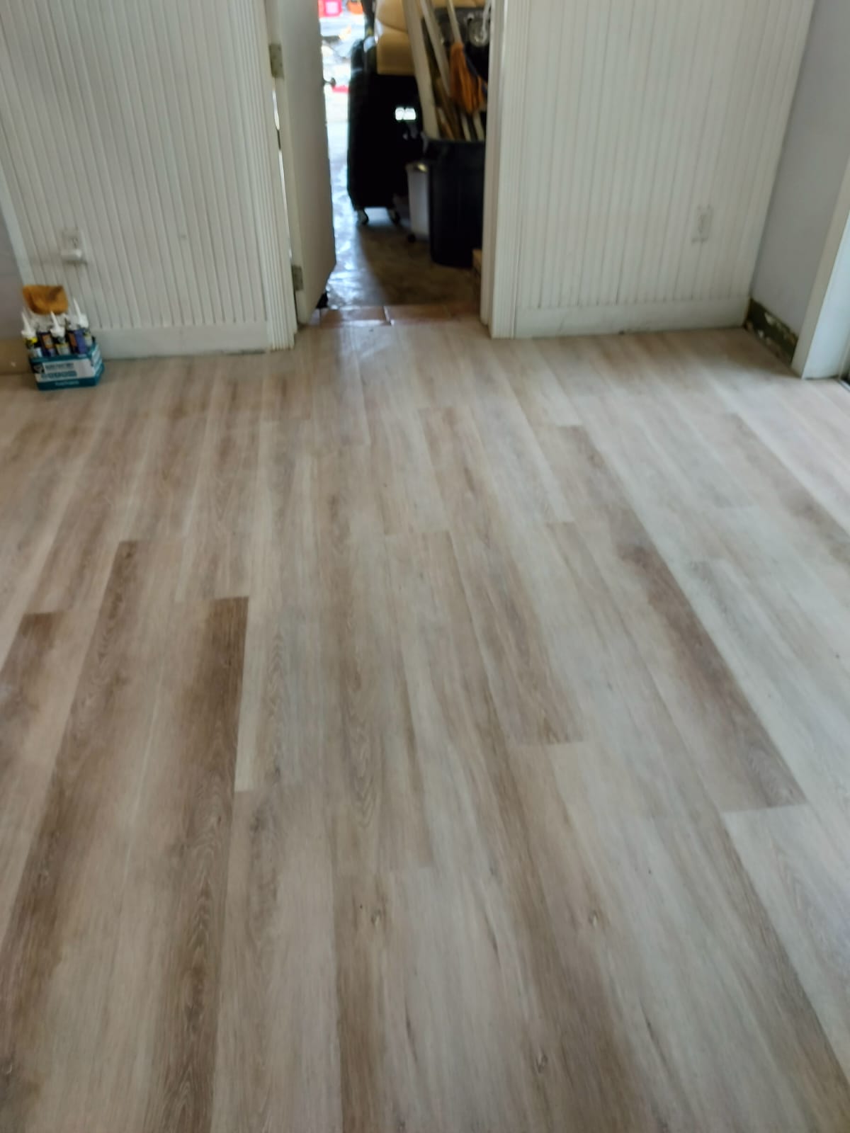 Hallway with newly installed light oak vinyl plank flooring